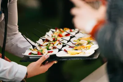 Canapé platters being served at a corporate function