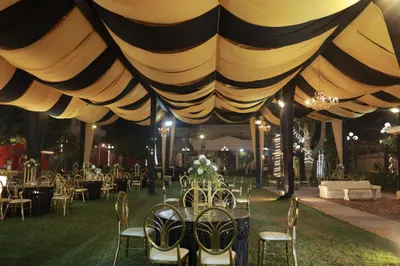 Gold and black draped marquee ceiling above lawn banquet seating