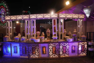 Illuminated outdoor food stall at an evening celebration