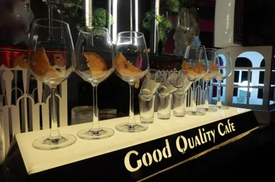 Welcome mocktails garnished with orange slices lined up on a lit bar counter
